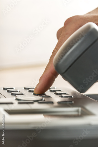 Closeup of a male hand making a phone call by dialing a classica