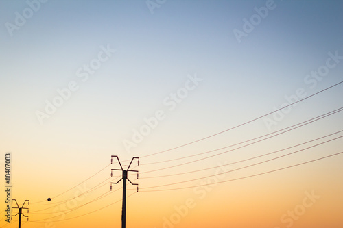 Electrical poles at sunset