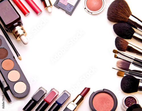 Set of professional cosmetic: make-up brushes, shadows, lipstick, nail polishes - partly isolated with shadows on white background. Overhead view. Front part. Place for your text.