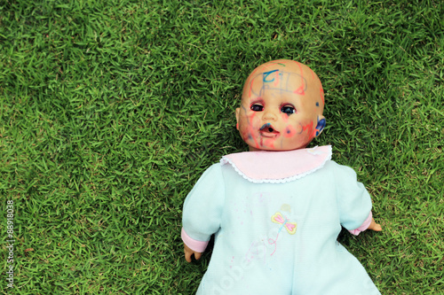 dirty doll on the grass