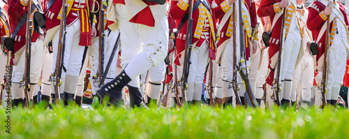 Legs of British soldiers of American revolutionary war on green battlefield in Lexington, MA