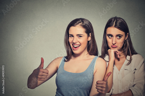 Optimistic lady having solution and bored, annoyed clueless sad woman