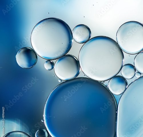 Oil drops on water surface, abstract macro background.