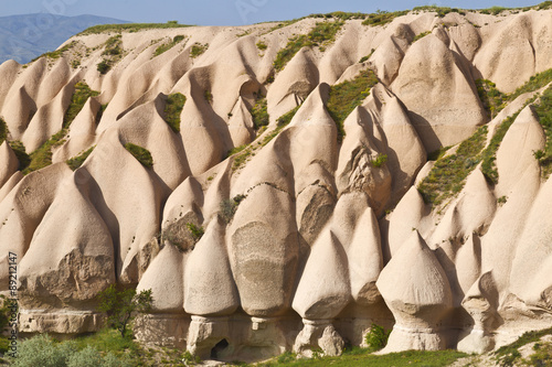 Beautiful barren landscape - ashen mountains (volcanic rock) - eerie carved structures , pink rocks, Goreme, Cappadocia, Central Anatolia, Turkey
