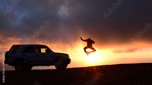 Man Jumping by a Car