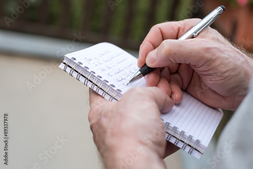 Man taking notes on a pocket book