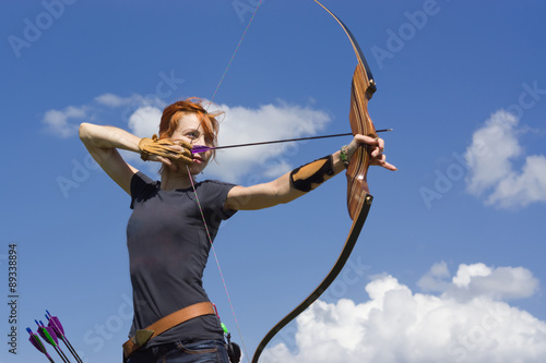 Archery woman bends bow archer target narrow