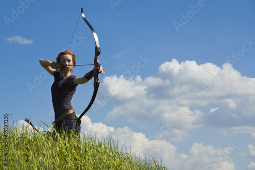 Archery woman bends bow archer target narrow