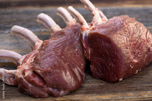 Fresh venison back on a wooden background