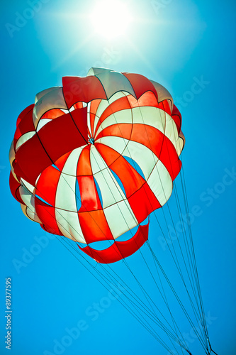 open parachute in the bright blue sky