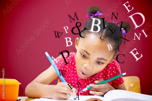 Composite image of cute pupil writing at desk in classroom