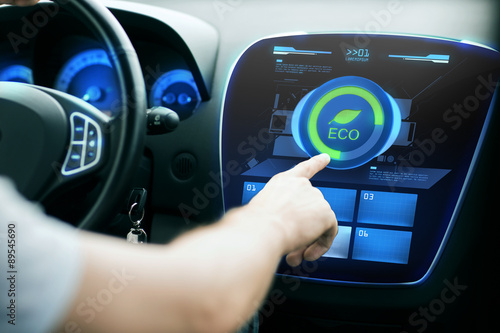 male hand setting car eco system mode on screen