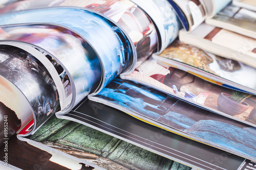 stack of open colorful magazines. information