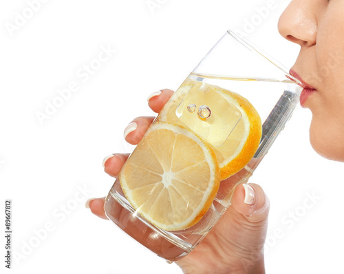 Woman drinking water with lemon