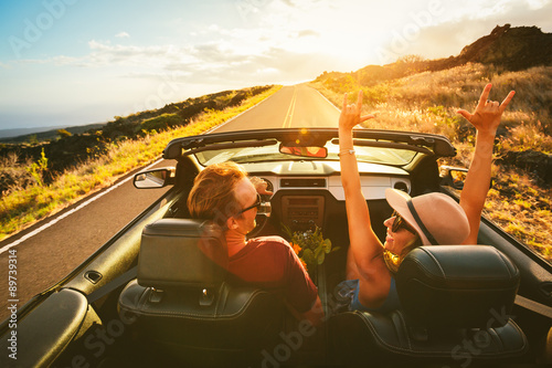 Happy Couple Driving in Convertible