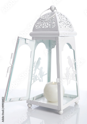 White metal lantern with candle