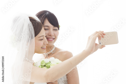 Two brides are taken by smartphone