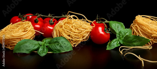 Group of three round balls of raw pasta on black