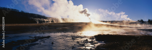 This is the famous Old Faithful Geyser. The geyser is erupting at sunrise.
