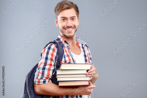Positive student holding books 