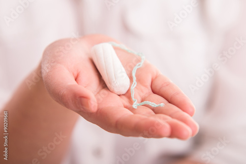 White woman's tampon on hand