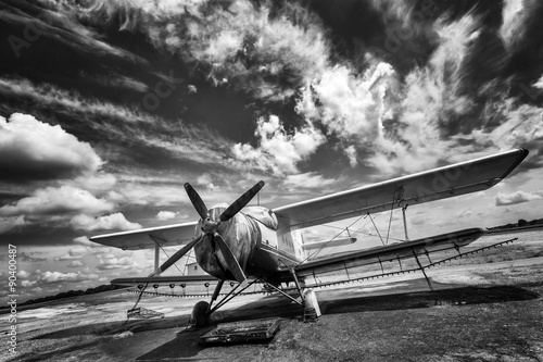 Old airplane on field in black and white