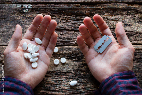 man wants to commit suicide by cutting the veins or eating pills