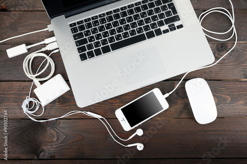 Computer peripherals and laptop accessories on wooden background