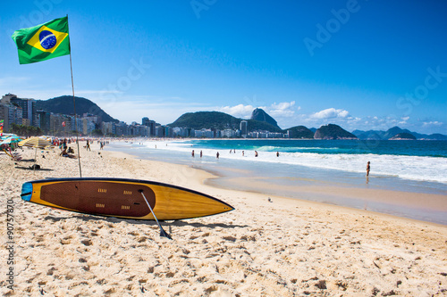 Brazilian flag and surfboard at Copacabana Beach, Rio de Janeir