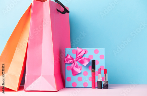 makeup cosmetics and gift box with shopping bags