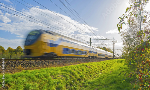 Train driving towards the sun in autumn