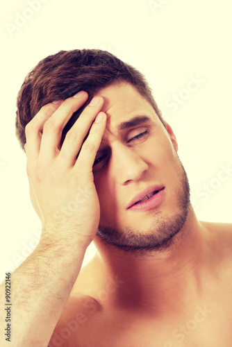 Athletic man feeling pain in his head.