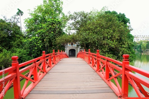 Huc Bridge over the Hoan Kiem Lake in Hanoi,Vietnam.The wooden red-painted bridge connects the shore and the Jade Island on which Ngoc Son Temple.