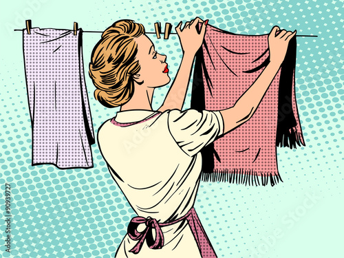 woman hangs clothes after washing housewife housework comfort