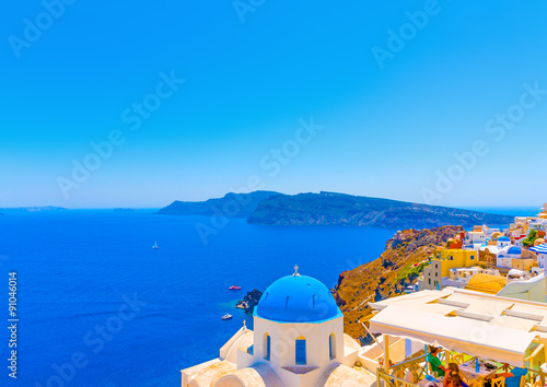 The blue colored dome of an old traditional church in Oia the most beautiful village of Santorini island in Greece