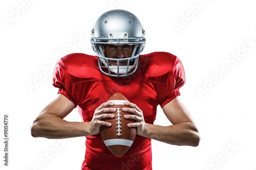 American football player in red jersey and helmet holding ball