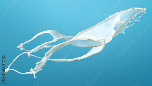 Milk splash isolated on blue. With clipping path.