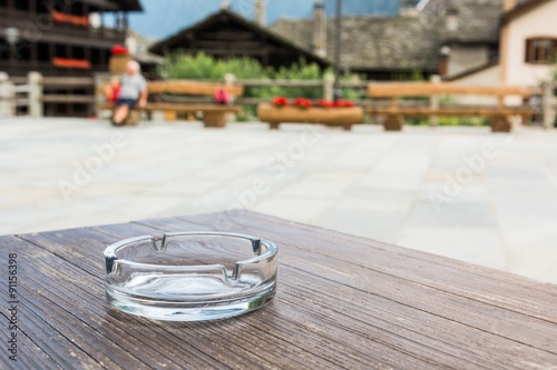 Empty glass ashtray on a wooden table