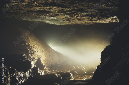 cave entrance with mist and light