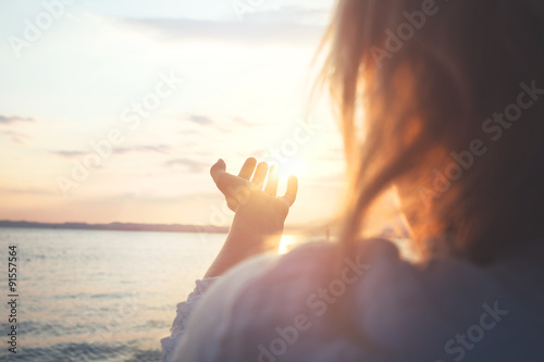 woman try to grab the sun