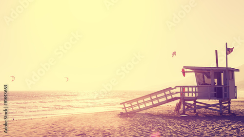 Vintage style picture of lifeguard tower at sunset in Malibu, California, USA.