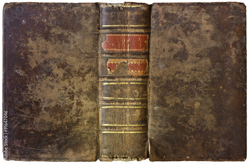 Old open book - worn brown leather cover with thick spine and abstract golden decorations - circa 1750 - isolated on white