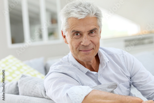 Portrait of elderly man relaxing in sofa at home