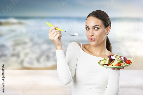 young attractive woman eating salad 