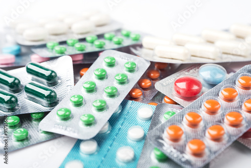 Pile of colorful medicine pills and capsules in blister packs