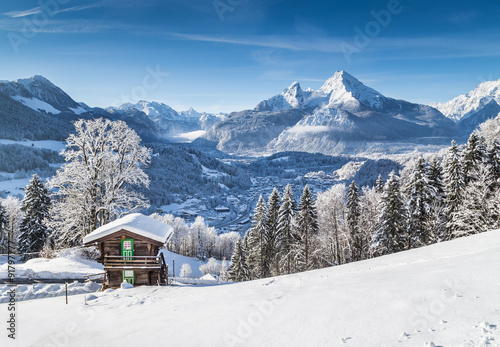 Idyllic winter landscape in the Alps with traditional mountain chalet