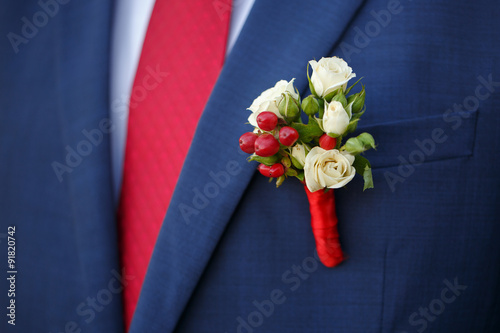 wedding boutonniere from rose on suit of groom