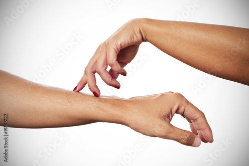 woman caressing with her fingertips the arm of a man