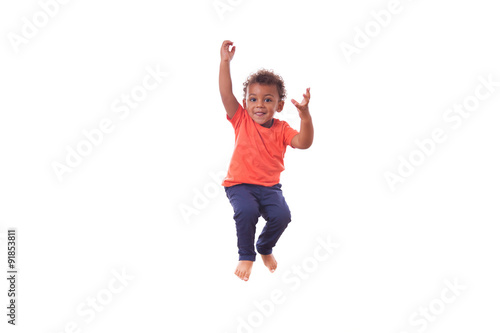 Portrait of a cute little African American boy jumping on a tram
