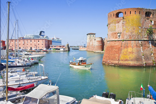 The Livorno's harbour with a ship sailing to the main Italian island
